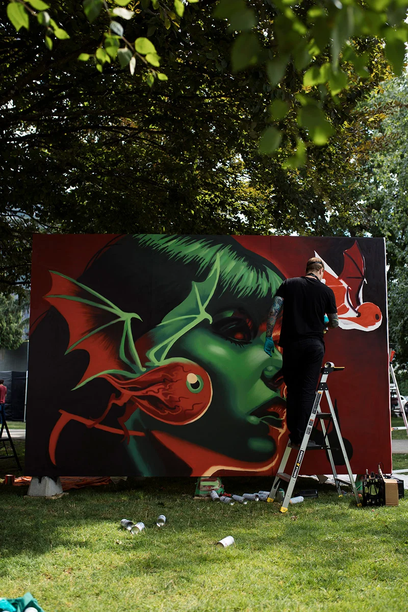 https://www.downtownsquamish.com/wp-content/uploads/2024/06/Squamish-Public-Art-Green-Woman-Mural-Alex-Wigley2.jpg.webp