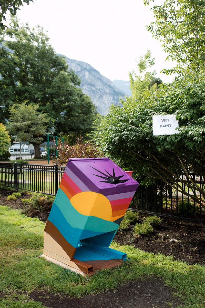 https://www.downtownsquamish.com/wp-content/uploads/2024/07/Squamish-Public-Art-Downtown-Squamish-BIA-Mural-Walk-Scenic-Bins-Gabriel2.webp