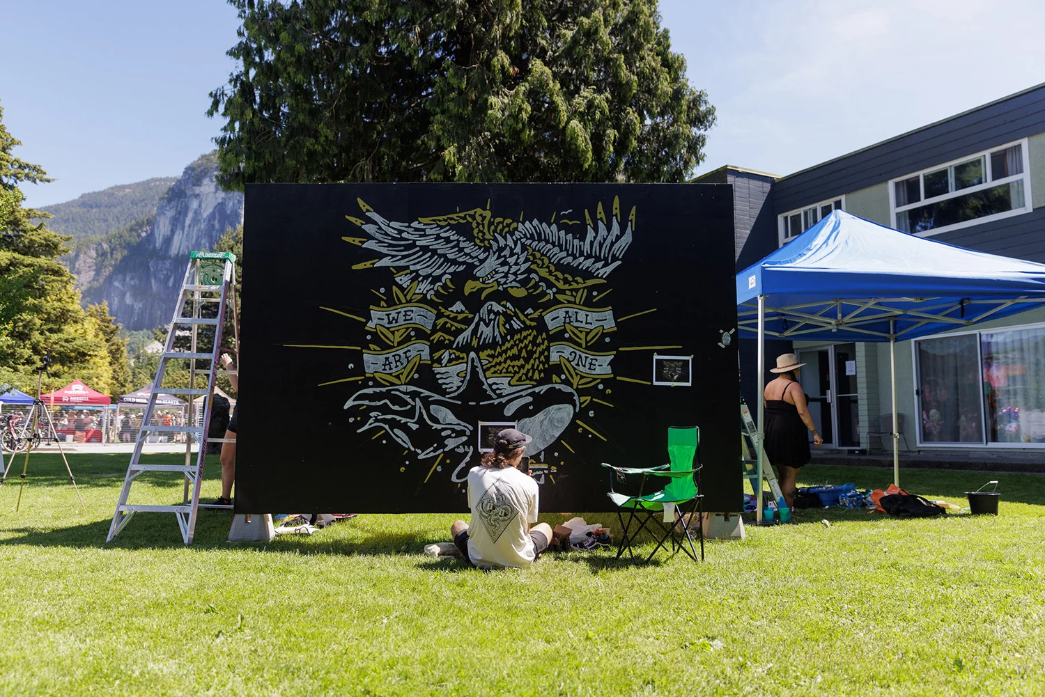 https://www.downtownsquamish.com/wp-content/uploads/2024/07/Squamish-Public-Art-Downtown-Squamish-BIA-Mural-Walk-We-Are-All-One2.webp